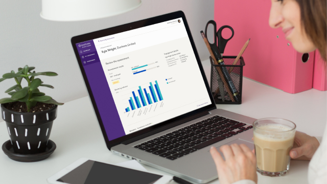 Lady with a cup of coffee using Grant Thornton app